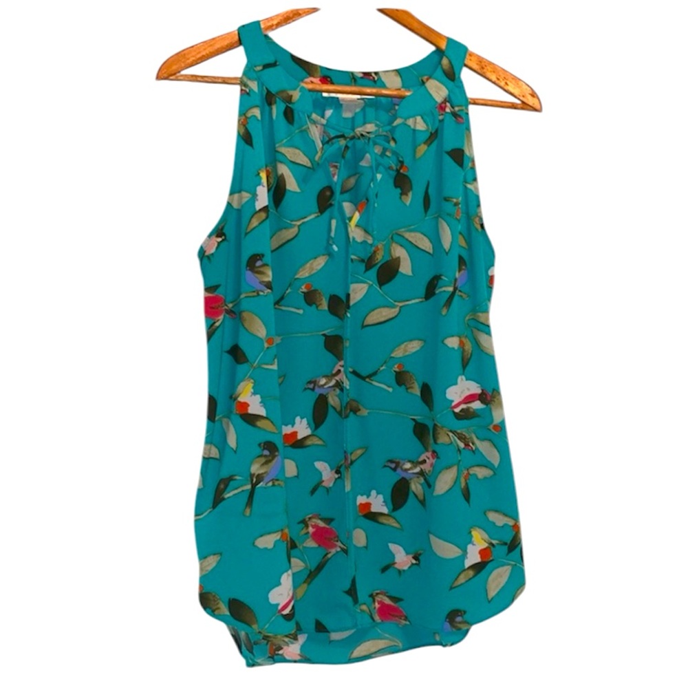 Women’s sleeveless scoop neck top with tie.  Aqua blue with bird pattern